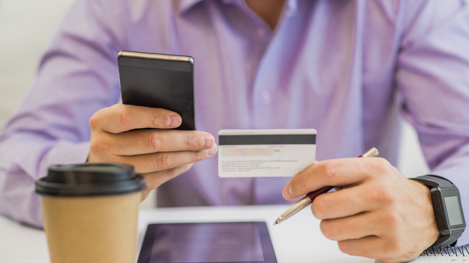 guy-hand-holding-credit-card-enjoying-internet-online-shopping-using-digital-computer-tablet-home