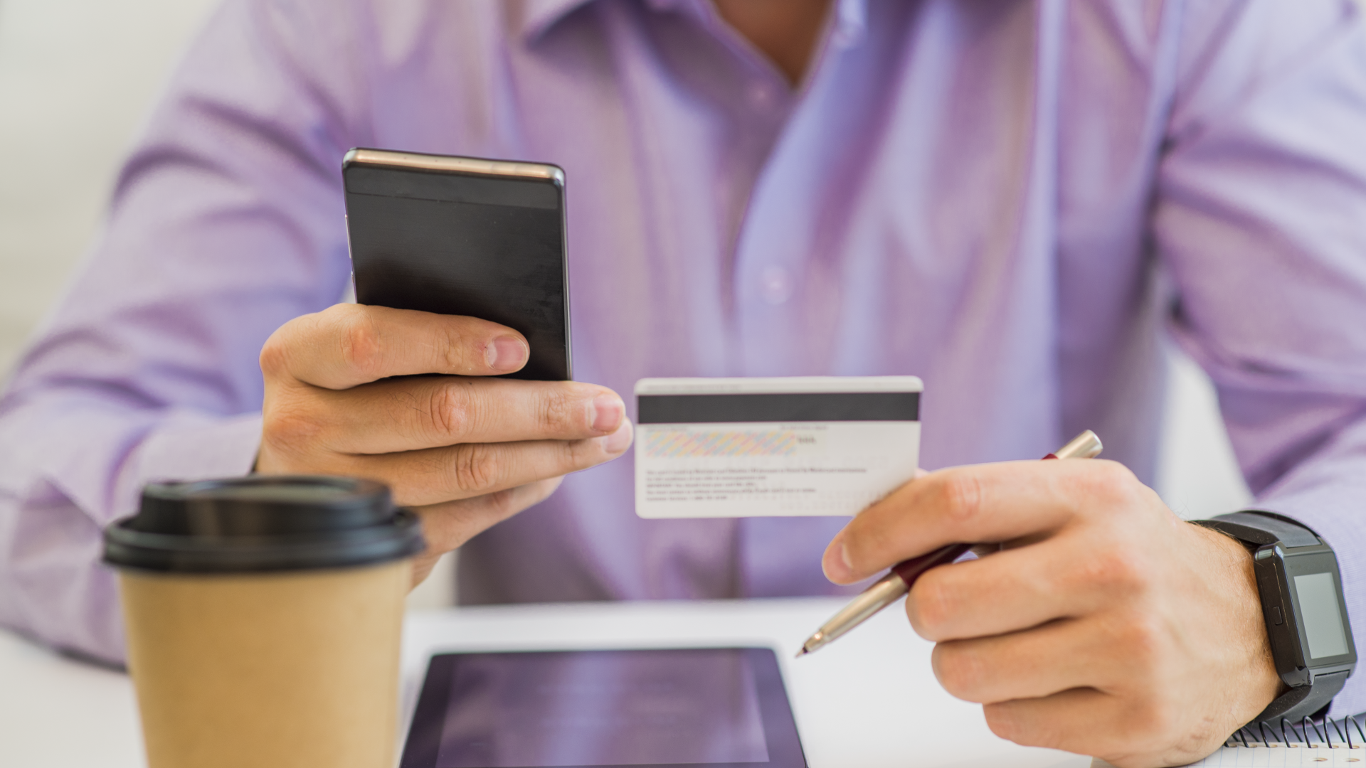 guy-hand-holding-credit-card-enjoying-internet-online-shopping-using-digital-computer-tablet-home